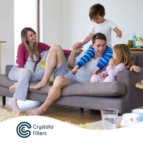 Family enjoying clean water with Crystal Filters product on living room sofa