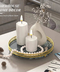 Green marble lazy susan turntable for table top with gold frame displaying candles and a vase.