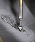 Close-up of Flat Ribbon Plastic Welding Rod Black 30 Ft used on plastic surface for ultra strong repairs with TPO carbon and glass fiber reinforcement