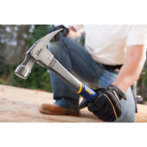 Person using Fiberglass Claw Hammer 16 Oz General Purpose With Forged Steel Head ProTouch Grip Smooth Face for framing on wood surface