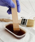 Mixing resin and hardener with a wooden stirrer from an All-In-One Fiberglass Repair Kit With Resin, Hardener, Cloth, And Tools For Automotive, Marine, And Home DIY Repairs - 0.45 Pint Waterproof Quick Fix Solution.