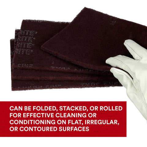 General Purpose Very Fine Aluminum Oxide Hand Pad For Scuffing And Cleaning 6x9, shown folded with a gloved hand.