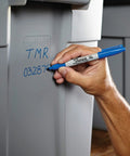 Hand using fine point permanent markers deliver bold, precise lines with quick-drying, odorless ink that resists fading and is waterproof on plastic bin.