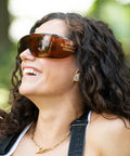 Woman wearing StarShield Fit Over Sunglasses With Lenses And Blue Light Blocking UV Protection outdoors