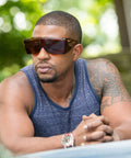 Man wearing StarShield Fit Over Sunglasses With Lenses And Blue Light Blocking UV Protection outdoors, showing sunglasses style.