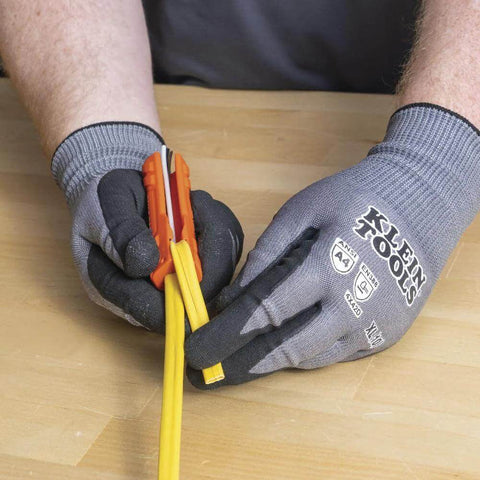Hands using Five In One Cable Stripping Tool For 12 To 14 AWG NM Cable Jacket Slitting And Precision Insulation Stripping For 12 To 14 AWG Conductors