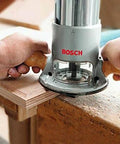 Image of Bosch fixed-base router in use, 2.25 HP, 12 Amp, showing precise edge work, Fixed Base Router 2.25 HP 12 Amp Variable Speed 8000 to 25000 RPM