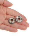 Hand holding Flanged Ball Bearing 1 Quarter By 5 Eighth By 0.196 Inch Double Shielded Chrome Steel FR4ZZ 4 Pack