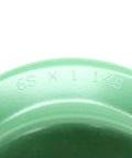 Close-up of Sure-Flex Flange Coupling 1-1/8 Inch Bore By TB Woods 6S118 showing engraved markings on green surface