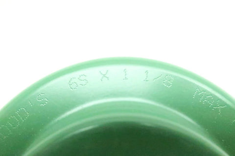 Close-up of Sure-Flex Flange Coupling 1-1/8 Inch Bore By TB Woods 6S118 showing engraved markings on green surface