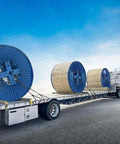Flatbed truck transporting large cable reels secured with ✝️ 3/8 Inch x 6 FT Grade 70 Binder Chain with Clevis Grab Hooks - G70 Transport Tow Chain