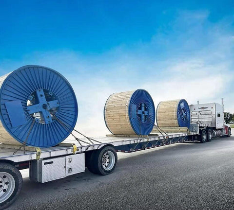 Flatbed truck transporting large cable reels secured with ✝️ 3/8 Inch x 6 FT Grade 70 Binder Chain with Clevis Grab Hooks - G70 Transport Tow Chain