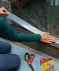 Flex Seal Draft and Insulation Sealing Tape being applied to a glass shower door, showing flexible and clear rubberized strip, 2 in x 16 ft.