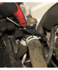 Flexible Hose Clamp Pliers For Automotive Radiator And Heater Hoses Install And Remove Spring Clamps In Hard To Reach Areas Flexible Cable Design With Multi Position Lock For Hands Free Use In Tight Engine Compartments being used to remove a clamp from a hose.