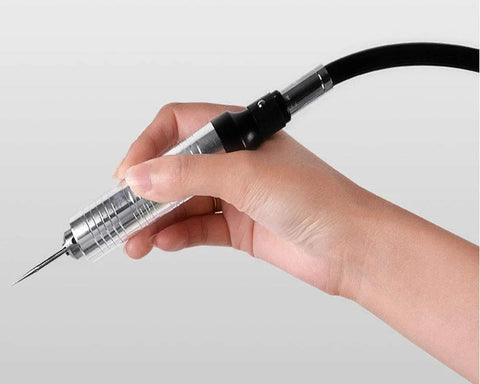 Person holding a Flexible Shaft Grinder Carver Rotary Tool Set with a precision attachment for crafting.