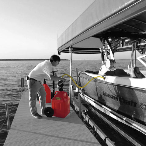 Man using FLO-FAST Pro Pump, 8GPM, to refuel boat dockside with a telescoping draw tube, portable and durable design, made in USA.