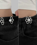 Close-up of Flower Jeans Button Sets Ten Pcs Adjustable Waist Tighteners Buckles installed on black jeans waistband.