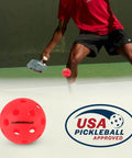 Player using Indoor Pickleball Balls Multi-Pack – 26 Hole Fluorescent Ember Pickleball Balls, USAPA Approved Indoor Pickleballs for Training