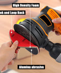 Five Inch Foam Sanding Pad Set 18 Pcs 180 3000 Grit For Wet Dry Orbital Sander being attached to an orbital sander with a hand