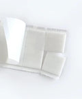 Close-up of Teacher Tape Pads Double Sided Removable Foam Tape For Wall Mounting 96 Pieces Per Pack with easy peel corner.