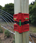 2 Pack Folding Magnetic Post Level For Pipe Post And Beams Leveling attached to a wooden post in outdoor setting