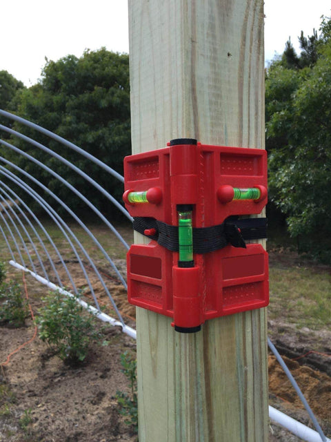 2 Pack Folding Magnetic Post Level For Pipe Post And Beams Leveling attached to a wooden post in outdoor setting