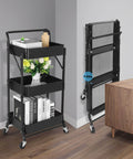 Foldable 3 Tier Metal Utility Rolling Cart With Locking Folding Design For Easy Storage And Mobility The Workhorse Trolley Organizer For Home Office Library Black, shown folded and unfolded next to a desk.