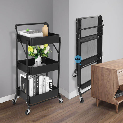Foldable 3 Tier Metal Utility Rolling Cart With Locking Folding Design For Easy Storage And Mobility The Workhorse Trolley Organizer For Home Office Library Black, shown folded and unfolded next to a desk.