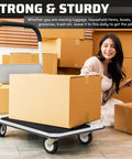 Heavy Duty Foldable Push Cart Dolly with 330 lbs. Capacity in use with cardboard boxes, woman seated nearby