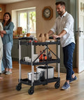 Man using Foldable Utility Cart On Wheels For Home Garage Office Or Restaurant With 3 Tier And 360 Degree Swivel Wheels Brakes