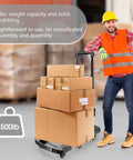 Worker with Folding Hand Truck 500lb Capacity With 6 Wheels Collapsible Luggage Cart And Elastic Ropes Portable Dolly, loaded with boxes.