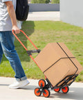 Man using Stair Climbing Cart 260 LBS, Portable Folding Aluminum Trolley Dolly for Stairs with box, 6 Mute Wheels, outdoor setting