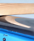 Close-up of a folding roller stand with a wooden plank, highlighting the heavy duty 300 LB load capacity, model KF3015 for smooth motion.