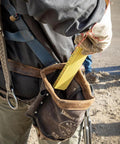 Worker using Folding Ruler 6-Foot Fiberglass With Brick Scale On Reverse And Outside Reading One Sixteenth Inch Graduation Riveted Lock Joints in field.