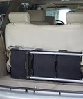 Pack N Roll Folding Collapsible Service Cart With 150 Lb Capacity, folded in the back of a vehicle, showcasing portability.