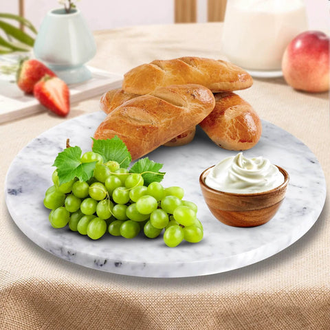 12 inch marble lazy susan turntable made from natural marble, rotating tray with croissants and grapes on a tabletop.
