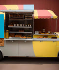 Food cart with folded drop down concession shelf displaying baked goods and snacks, suitable for snack bar or movie theater use.