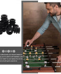 Hard Rubber Foosball Bumpers Set 15 Pack Pro Grade Replacement Bushings And Rod Bearings For Foosball Tables shown next to foosball table