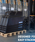 Tilt Dump Cart With Forklift-Ready Frame, Half Yard Capacity, 12-Inch Non-Marking Wheels And 5-Inch Casters, 850-Pound Load, Heavy-Duty Trash Cart For Jobsites, DUC12T-F-NM-03PK Three-Pack stacked on a pallet in a warehouse next to a forklift.