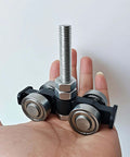Four Wheel Silent Trolley Rollers Assembly For Unistrut Channel With Hidden Bolt Design Compatible With One And Five Eighths Inch Wide And Taller Strut Channels Black Finish Pack Of Two Designed For Smooth Quiet Operation On Warehouse Racking And shown in hand.
