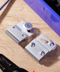 Close-up view of 4 Pcs M 6145 Frameless Shower Door Roller Top Bracket Assembly with 3/4 in plastic wheel on chrome aluminum brackets.