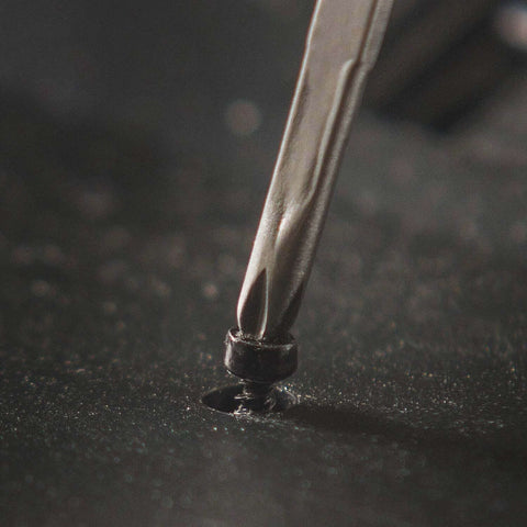 Close-up of Framework Mini 11 In 1 Multitool Open Frame using Phillips screwdriver on screw
