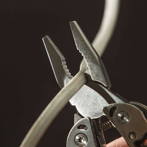 Framework Mini 11 In 1 multitool open frame with needle nose pliers and wire cutters cutting cable in close-up view