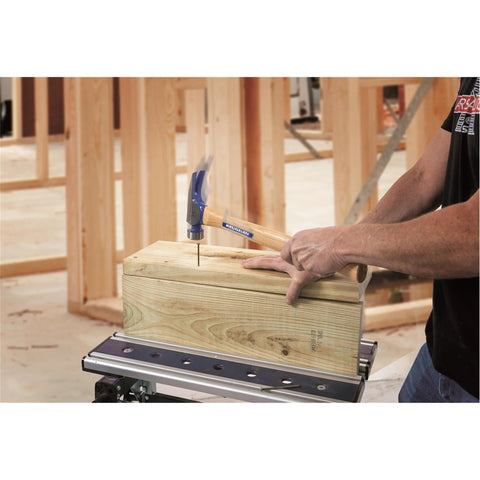 Framing hammer with a 23 oz milled head and nail starter grips nails flush for wood framing, decks, straight claw, in use.