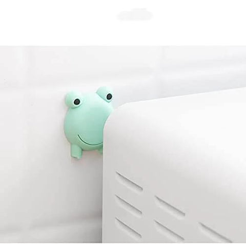 Green frog-shaped wall protector behind cabinet, part of 10 Pack Doorknob Wall Mute Cushion Silencer For Doors And Cabinets Eco Friendly Silicone Anti Collision Door Stopper With Wall Protection And Compact Storage Yellow