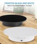 Black and white motorized 360 degree rotating display stands with velvet tops on wooden surface, ideal for jewelry presentation