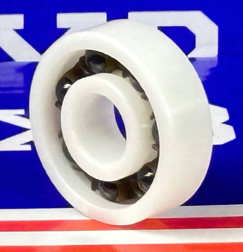 Full Ceramic ZrO2 608 Miniature Ball Bearing: Si3N4 Balls, Nylon Cage 8x22x7mm on a colorful background.