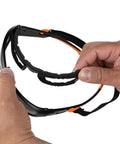 Hands holding Full Frame Gasket Safety Glasses With Foam Seal Anti Fog UV Scratch Resistant, showing detachable foam gasket.