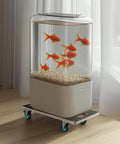 Fish tank on moving dolly with goldfish, placed on a wooden floor. Dolly features four TPR silent wheels for smooth motion.