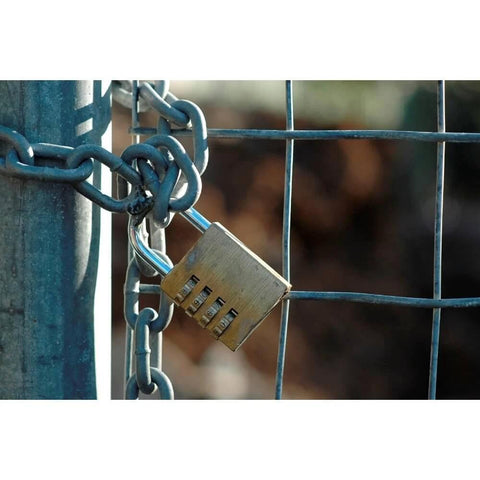 ✝️ 559881 1/4-inch x 25 ft. Galvanized Steel Proof Tested Coil Chain securing a gate with a padlock, Grade 30, 1300 lb. load.